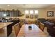Kitchen and dining area with wood table and dark cabinetry at 2040 Port Royal Dr, Laughlin, NV 89029
