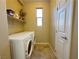 Well-organized laundry room with a washer, dryer and functional storage shelf at 2040 Port Royal Dr, Laughlin, NV 89029