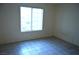 A bedroom with tile flooring, a window, and neutral-colored walls at 2121 Sealion Dr # 105, Las Vegas, NV 89128