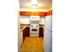 A functional kitchen featuring white appliances, a tile floor and ample cabinet storage at 2121 Sealion Dr # 105, Las Vegas, NV 89128