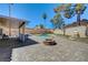 Inviting backyard with a pool, a covered patio, a firepit, and mature trees, perfect for entertaining at 2240 Grayson Cir, Henderson, NV 89014