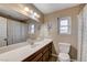 Bathroom featuring a large mirror, extended vanity and modern toilet at 2240 Grayson Cir, Henderson, NV 89014
