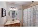 Cozy bathroom featuring a vanity with framed mirror, and a shower with a patterned curtain at 2240 Grayson Cir, Henderson, NV 89014