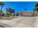 Charming single-story home with a red tile roof, lush landscaping, and a spacious driveway at 2240 Grayson Cir, Henderson, NV 89014