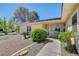 Inviting front entrance with a covered porch, desert landscaping, and a well-maintained walkway at 2240 Grayson Cir, Henderson, NV 89014