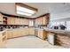 Spacious kitchen features ample counter space, light wood cabinets, and stone accents on the breakfast bar at 2240 Grayson Cir, Henderson, NV 89014