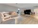 Open living room area featuring a large sectional sofa, light wood flooring, and neutral decor at 2240 Grayson Cir, Henderson, NV 89014