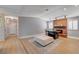 Open-concept living room featuring light wood flooring, recessed lighting, and a brick fireplace at 2240 Grayson Cir, Henderson, NV 89014
