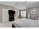 Bedroom with large bed, ceiling fan, wood shuttered windows and an adjacent ensuite bathroom at 2240 Grayson Cir, Henderson, NV 89014