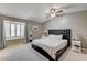 A spacious bedroom featuring neutral tones, a ceiling fan and a window with wood shutters at 2240 Grayson Cir, Henderson, NV 89014