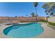 Private backyard pool with a baja shelf, surrounded by mature trees, and lush landscaping at 2240 Grayson Cir, Henderson, NV 89014