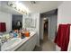 Bright bathroom featuring double sinks, granite counters, and a large mirror at 2266 Carved Canyon Ln, Laughlin, NV 89029