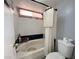 Bathroom with a tub and shower combo, white tiled walls, and updated fixtures at 2266 Carved Canyon Ln, Laughlin, NV 89029