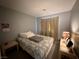 Neutral bedroom featuring a queen bed, bedside tables and curtains over the window at 2266 Carved Canyon Ln, Laughlin, NV 89029