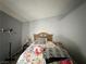 Cozy bedroom with a queen bed, a floral comforter, and neutral wall paint at 2266 Carved Canyon Ln, Laughlin, NV 89029