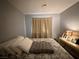 Neutral bedroom with bed featuring many pillows and end table with lamp at 2266 Carved Canyon Ln, Laughlin, NV 89029