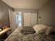 Neutral bedroom featuring queen sized bed, closet, and entrance to the hallway at 2266 Carved Canyon Ln, Laughlin, NV 89029