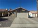 Exterior of the house featuring well-maintained landscaping, stucco and red tiled roof at 2266 Carved Canyon Ln, Laughlin, NV 89029