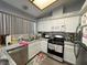 Well-lit kitchen featuring stainless steel appliances and gray countertops at 2266 Carved Canyon Ln, Laughlin, NV 89029