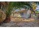 A view of the home's backyard with mature trees, hardscape and access to home at 2367 E Hacienda Ave, Las Vegas, NV 89119