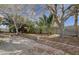 Landscaped backyard with trees, palms, and hardscape, offering outdoor relaxation at 2367 E Hacienda Ave, Las Vegas, NV 89119