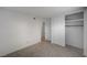 Bright bedroom with neutral walls, tile flooring, and closet with sliding doors at 2367 E Hacienda Ave, Las Vegas, NV 89119