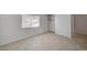 Bright bedroom features neutral walls, tiled floor, a window, and a closet with bi-fold doors at 2367 E Hacienda Ave, Las Vegas, NV 89119