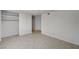 Bright bedroom features neutral walls, tiled floor, and a closet with sliding doors at 2367 E Hacienda Ave, Las Vegas, NV 89119