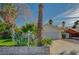 Charming home exterior with a two-car garage, mature trees, and drought-tolerant landscaping at 2367 E Hacienda Ave, Las Vegas, NV 89119