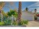 Inviting home exterior with a two-car garage, mature trees, and low-maintenance landscaping at 2367 E Hacienda Ave, Las Vegas, NV 89119