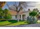 Inviting front yard featuring lush lawn, mature trees, and vibrant greenery enhance curb appeal at 2367 E Hacienda Ave, Las Vegas, NV 89119
