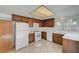 Well-lit kitchen with wood cabinets, white appliances, and tile flooring at 2367 E Hacienda Ave, Las Vegas, NV 89119