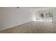 Open-concept living area with neutral walls, tiled floors, and sliding glass door access at 2367 E Hacienda Ave, Las Vegas, NV 89119