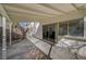 This covered patio has smooth concrete, leading to the window and sliding door to the interior at 2367 E Hacienda Ave, Las Vegas, NV 89119