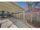 Spacious covered patio with concrete flooring, decorative brick walls, and mature tree providing shade at 2367 E Hacienda Ave, Las Vegas, NV 89119