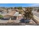 Aerial view of a cozy home with a covered patio, gravel yard, storage shed, and fenced yard, perfect for outdoor enjoyment at 3100 S Fallwood St, Pahrump, NV 89048