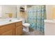 Bathroom featuring a vanity, toilet, and shower/tub combination with a colorful curtain at 313 Haley Way # D, Mesquite, NV 89027