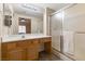 Well-lit bathroom featuring a vanity with a large mirror and a glass-enclosed shower at 313 Haley Way # D, Mesquite, NV 89027