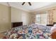 Comfortable bedroom featuring a ceiling fan, a dresser, and a window with vertical blinds at 313 Haley Way # D, Mesquite, NV 89027