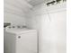 Laundry room with a washing machine and wire shelving for organized storage at 313 Haley Way # D, Mesquite, NV 89027