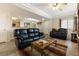 Living room features tiled flooring, ceiling fan, and views to the kitchen at 313 Haley Way # D, Mesquite, NV 89027