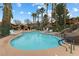 Community pool area offers a refreshing escape, surrounded by palm trees and lounge chairs at 313 Haley Way # D, Mesquite, NV 89027