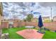 Private backyard with brick-paved patio, artificial turf, and a secure brick perimeter for outdoor enjoyment at 3237 Mist Effect Ave, Henderson, NV 89044