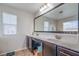 Bathroom with double sinks, spacious mirror, and abundant lighting at 3237 Mist Effect Ave, Henderson, NV 89044