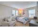 Cozy bedroom featuring a comfortable chair and ample natural light at 3237 Mist Effect Ave, Henderson, NV 89044