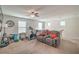 Versatile bonus room features a sectional sofa, fitness equipment, and a ceiling fan at 3237 Mist Effect Ave, Henderson, NV 89044