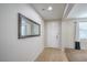 Bright entryway with neutral tile floors, white walls, and a decorative mirror at 3237 Mist Effect Ave, Henderson, NV 89044
