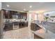 Modern kitchen with stainless steel appliances, granite countertops, and dark wood cabinets at 3237 Mist Effect Ave, Henderson, NV 89044
