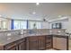 Stylish kitchen featuring dark cabinetry, granite countertops, and stainless steel appliances at 3237 Mist Effect Ave, Henderson, NV 89044