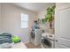 Functional laundry room with modern washer and dryer, shelf space, and natural light at 3237 Mist Effect Ave, Henderson, NV 89044
